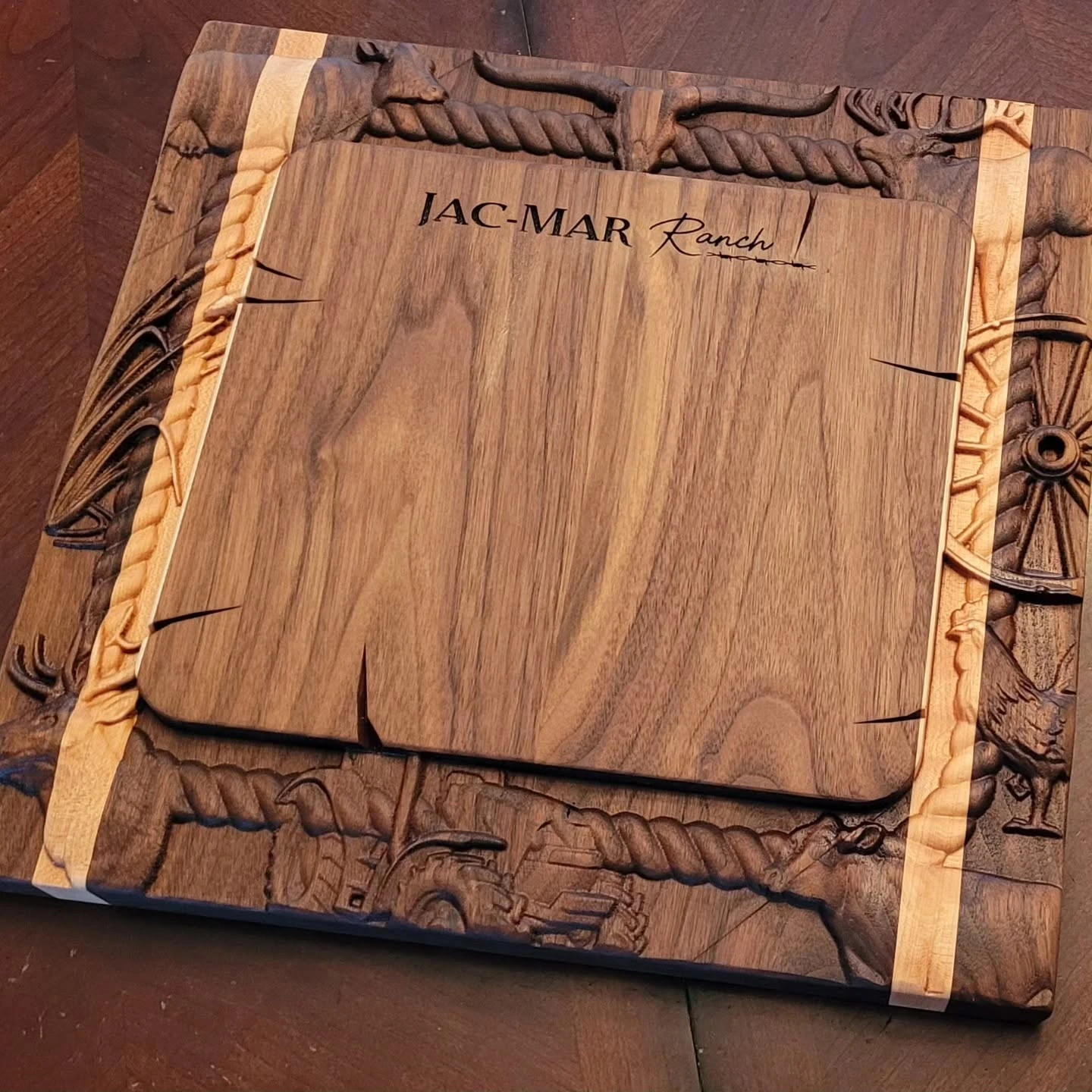 Carved wood cutting board with ranch branding and decorative relief border