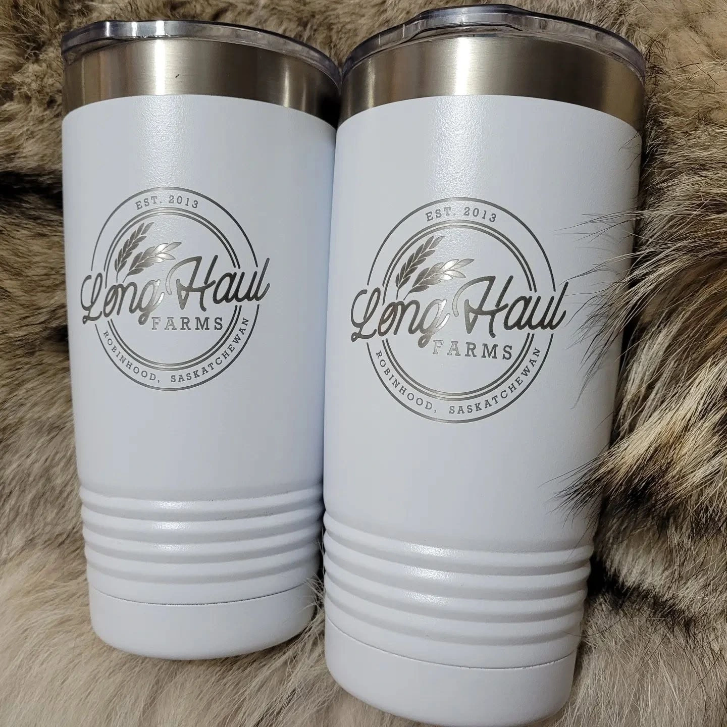 Two white branded travel mugs