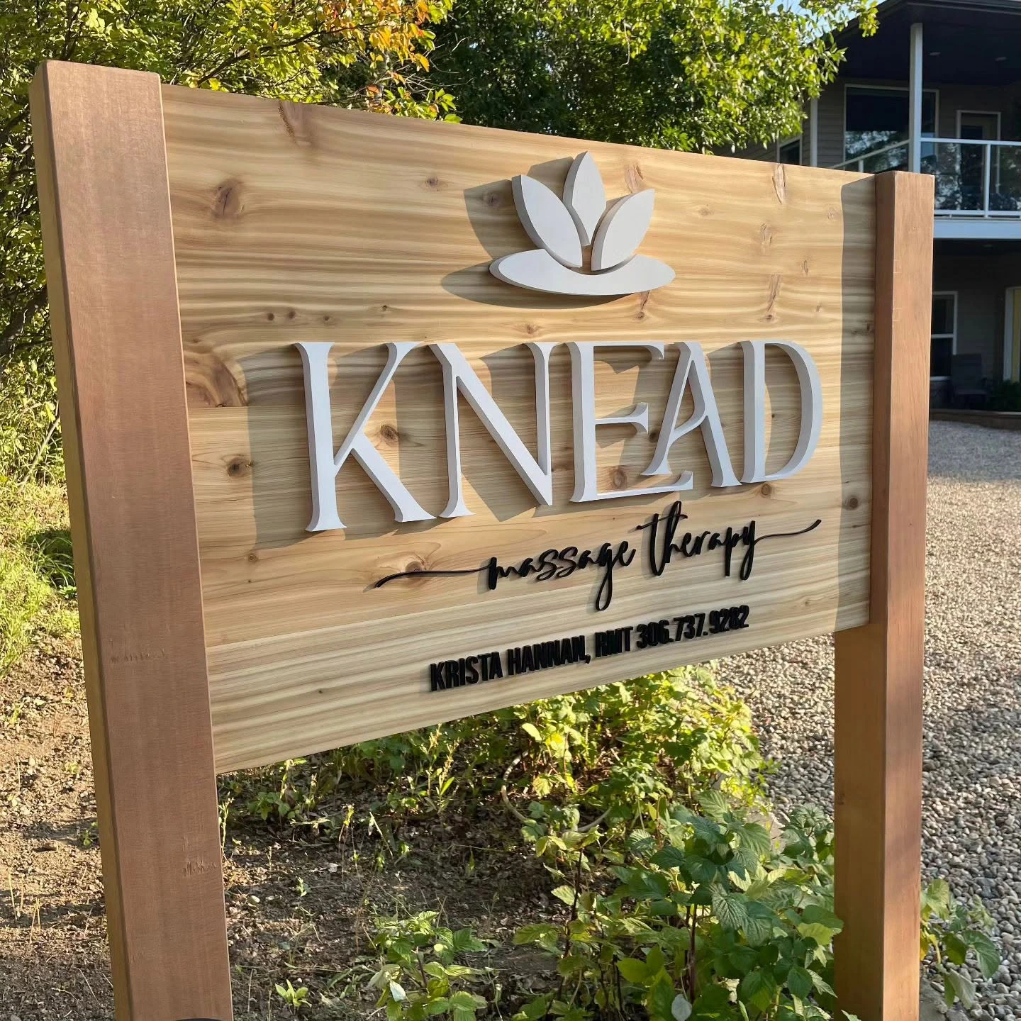 Outdoor wood business sign reading Knead