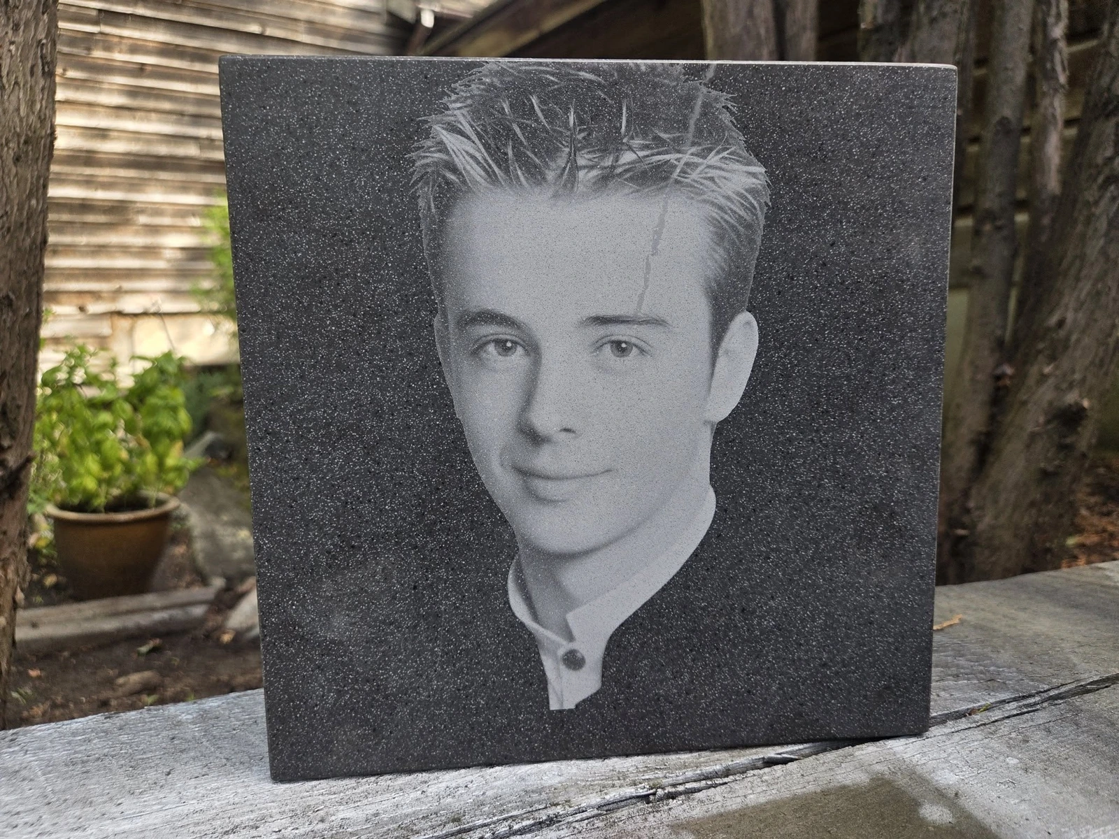Portrait engraved into a dark stone panel