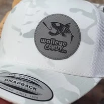 Light patterned cap with a round Walleye Camp logo patch