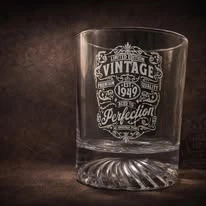 Glass with decorative vintage lettering engraved on its surface