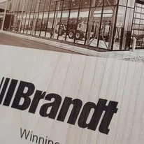Milestone plaque with industrial imagery and Brandt branding