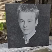 Portrait engraved into a dark stone panel